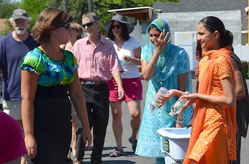 Sikh women offer water